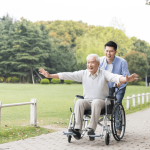 高雄長照補助-一位青年正帶著年長者出門散步